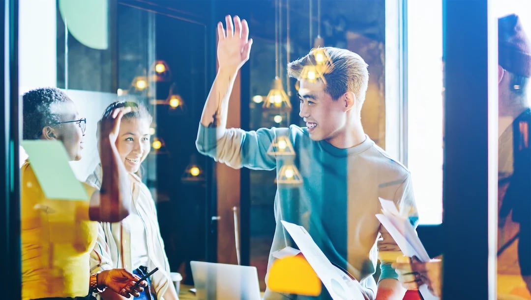 Create team high fiving each other after succesful project delivery